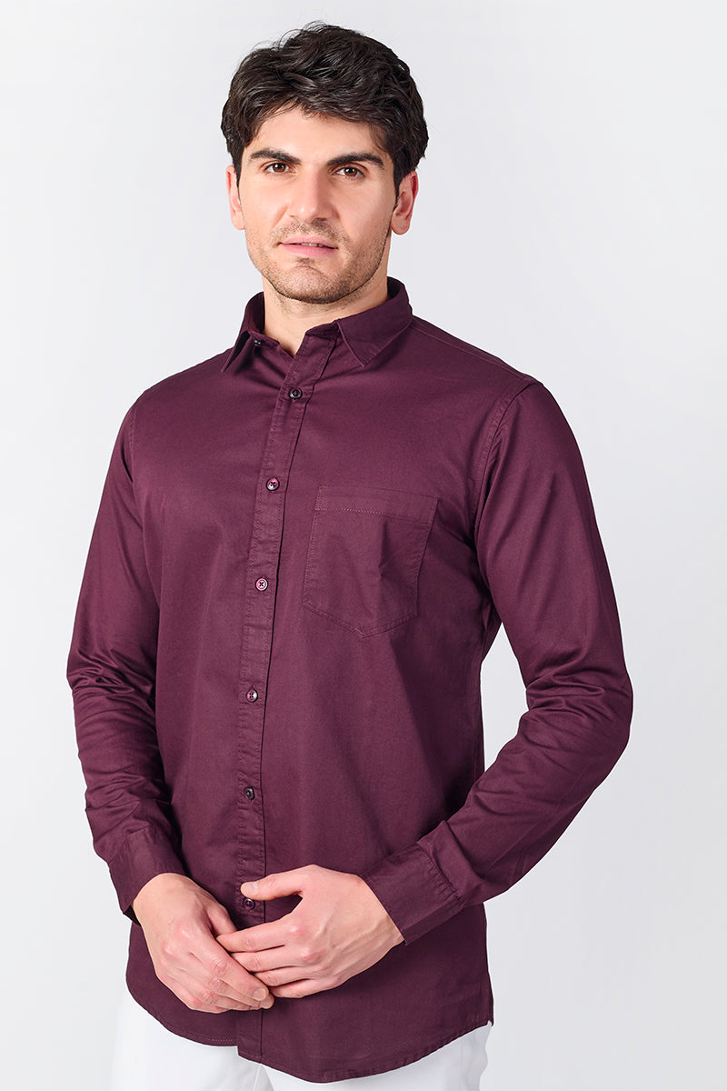 Man wearing a purple shirt against a white background